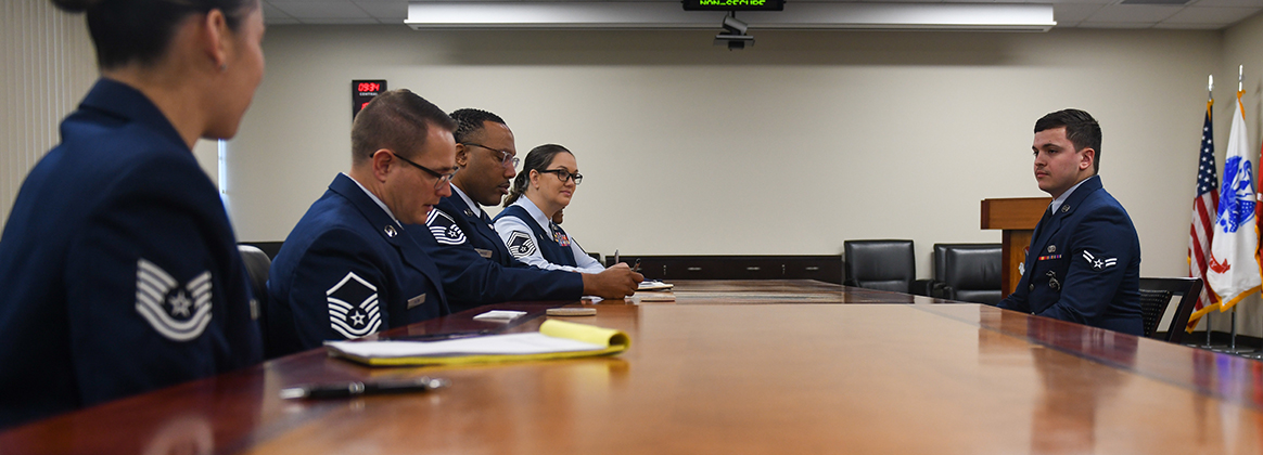 A photo of an Airmen meeting a BTZ board.